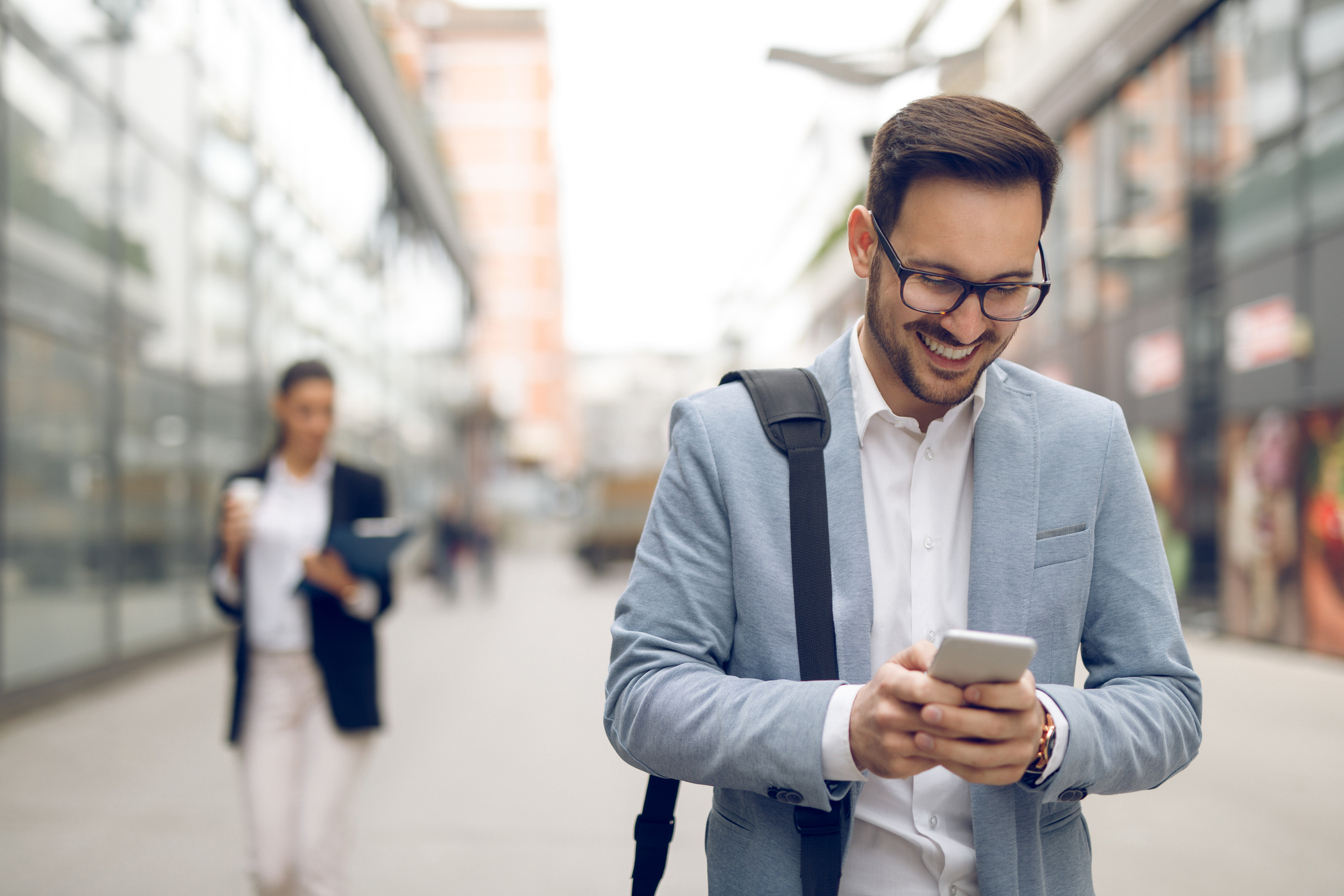 person walking outside looking at phone