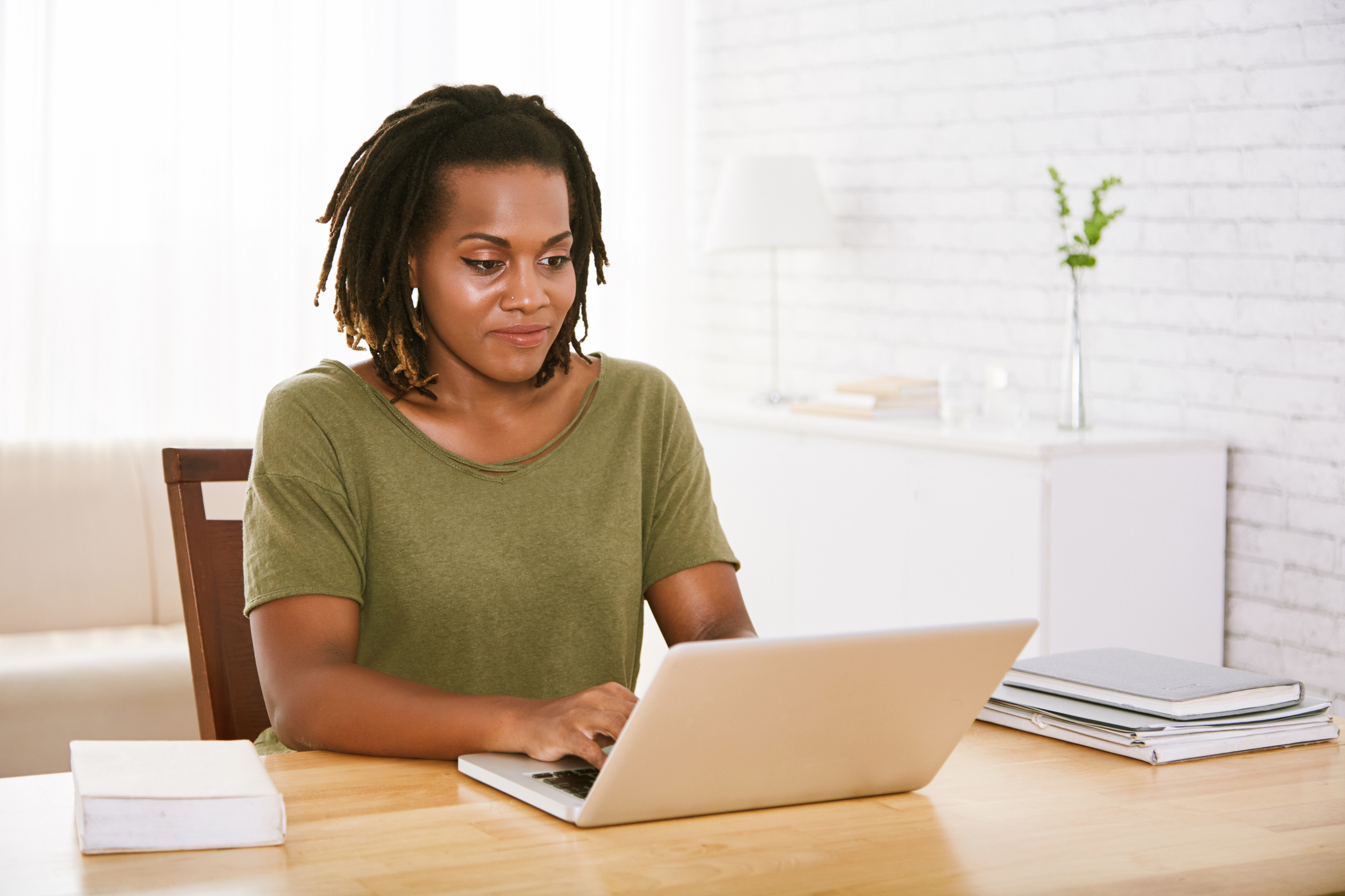 person sitting at table with laptop